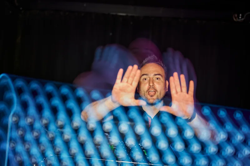 Tomy at the mixing desk during a performance.