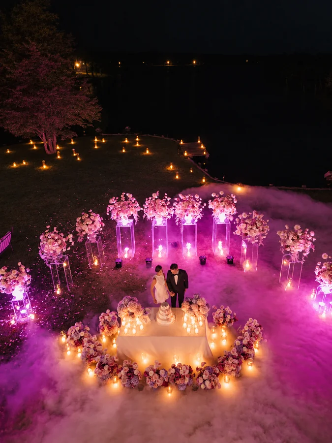 An overhead view of an elegant evening celebration with coloured lighting.