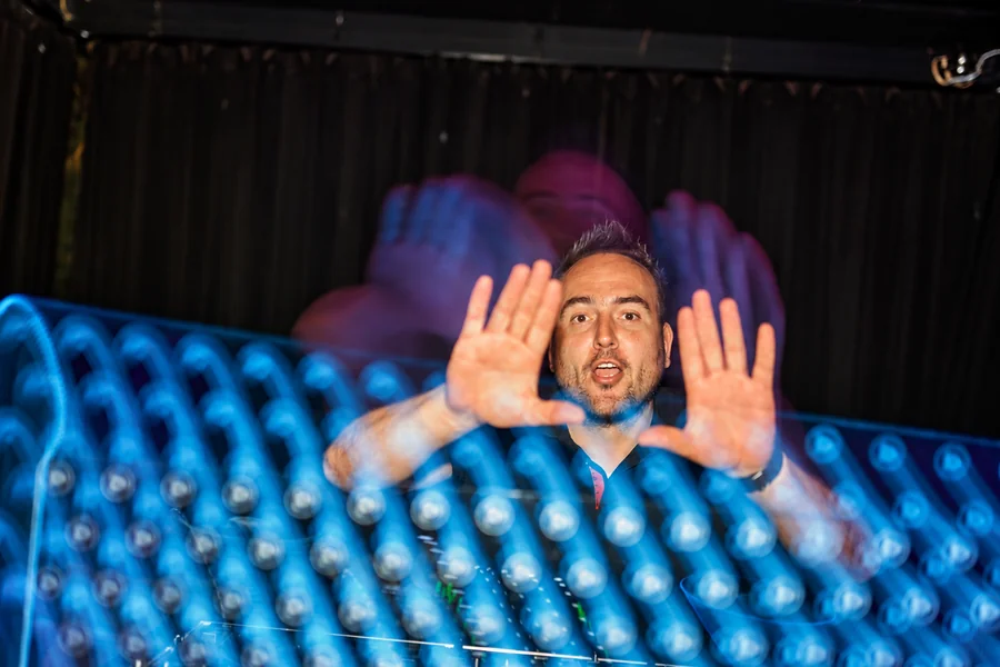 Tomy at the mixing desk during a performance.