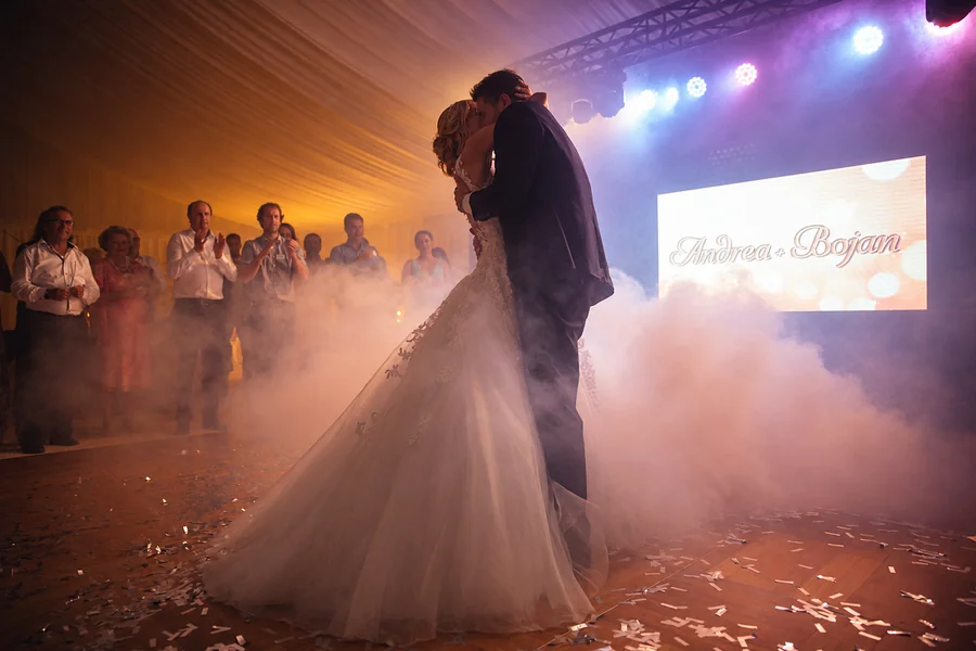 A wedding couple dancing in soft evening light.