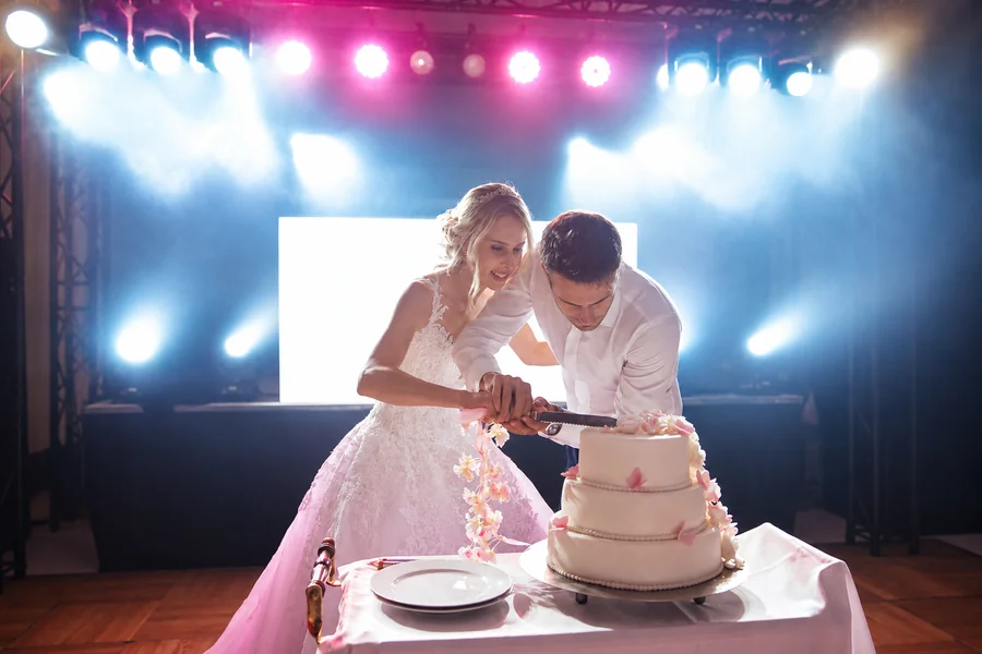 A wedding couple cutting their cake.